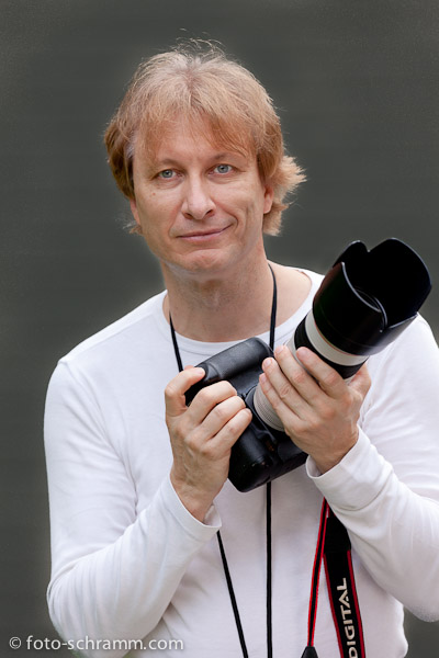 Portrait of photographer Norbert Schramm with his Canon action photography equipment